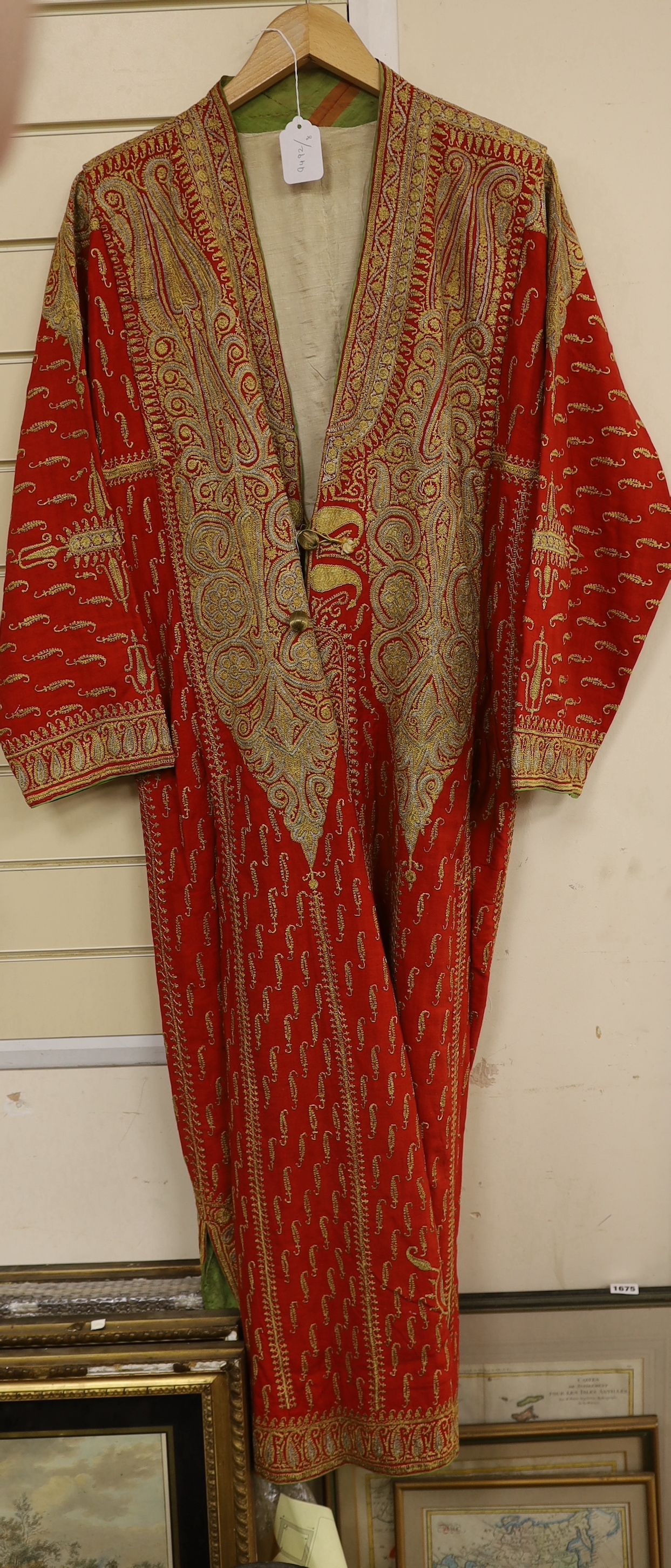 A 19th century fine wool coat, embroidered with gold and silver coloured metal threads in an all over paisley design